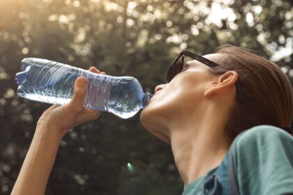 Frau trinkt aus flasche